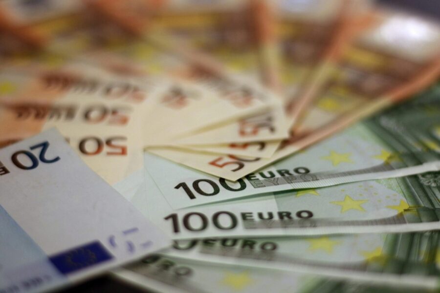 Close-up of various euro banknotes fanned out, symbolizing wealth and financial success.
