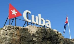 Cuba sign and flag against a clear blue sky in Havana, Cuba.