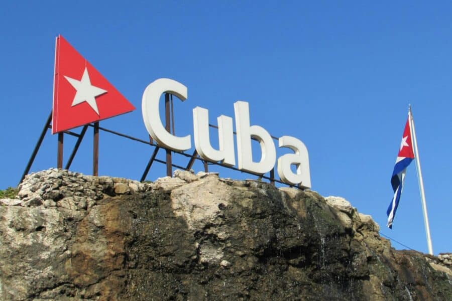 Cuba sign and flag against a clear blue sky in Havana, Cuba.
