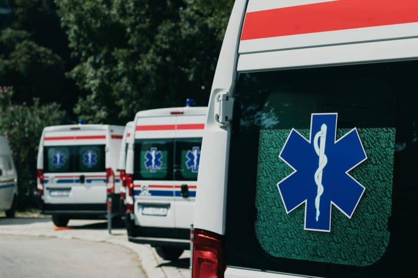 Three ambulances parked outdoors, ready for emergency healthcare situations.