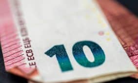 Detailed close-up of a ten euro banknote highlighting currency design and texture.