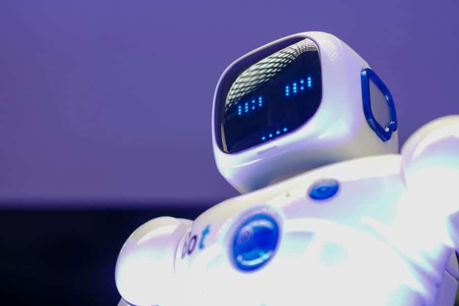 A modern humanoid robot with digital face and luminescent screen, symbolizing innovation in technology.