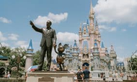 a statue of a man in front of a castle