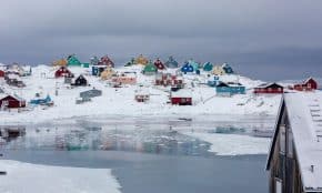 view photography of assorted-color houses near pond during daytime