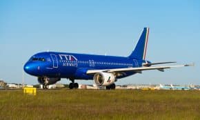 a large blue airplane is on the runway