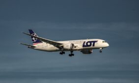 a large jetliner flying through a blue sky
