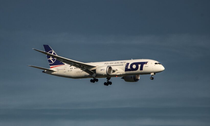 a large jetliner flying through a blue sky