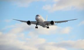 white passenger plane in mid air during daytime