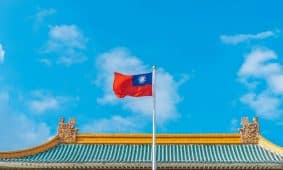 a red and blue flag on top of a building