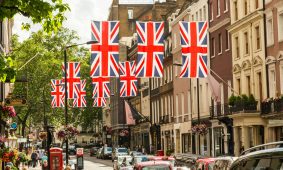 a british flag hanging over a city street