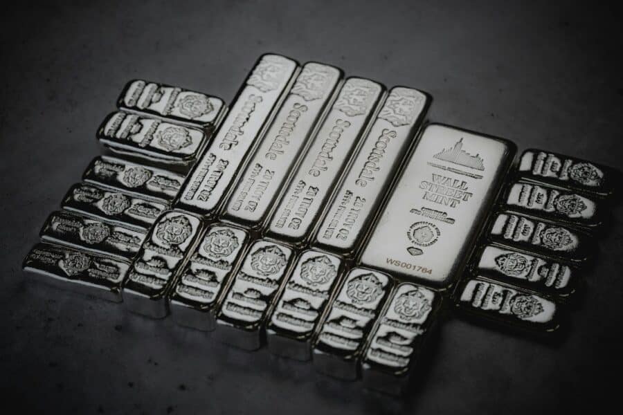 a pile of silver bars sitting on top of a table