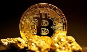 a bitcoin sitting on top of a pile of gold nuggets