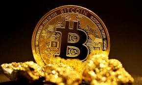 a bitcoin sitting on top of a pile of gold nuggets