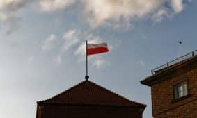 a red and white flag on top of a building