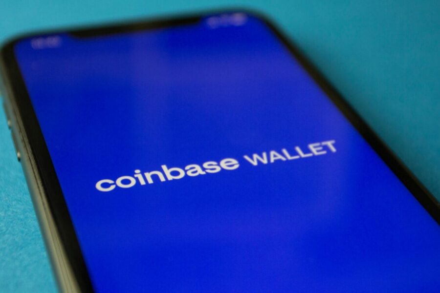 Close-up of a smartphone showing the Coinbase Wallet app interface for cryptocurrency transactions.