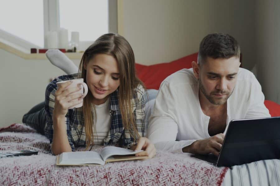 Couple reviewing mortgage documents home laptop