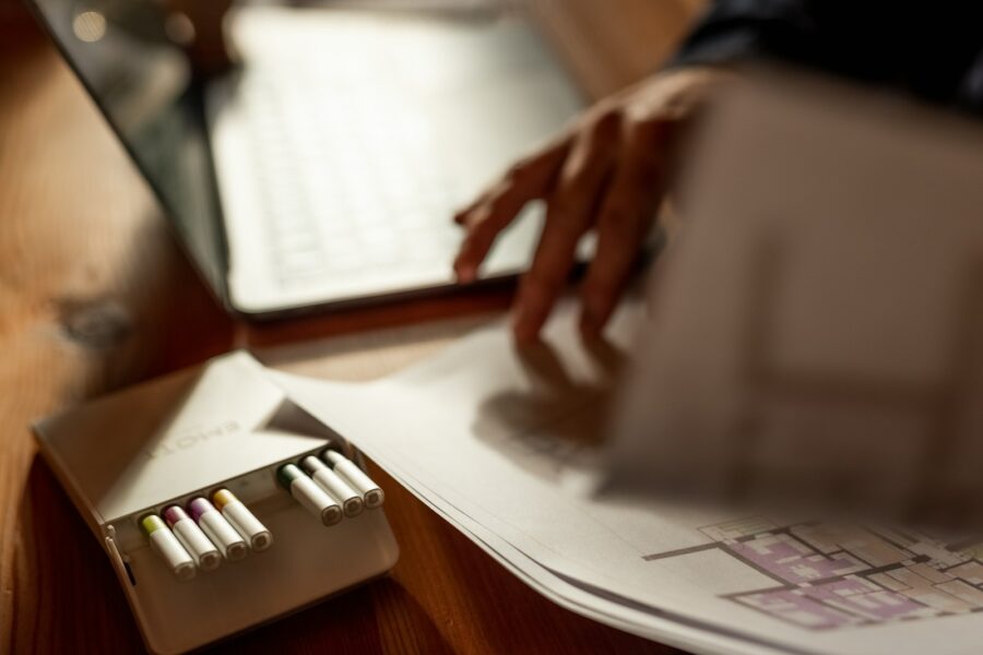 Person calculating bills credit card notebook home desk