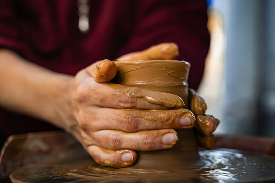 Hands pottery wheel clay studio