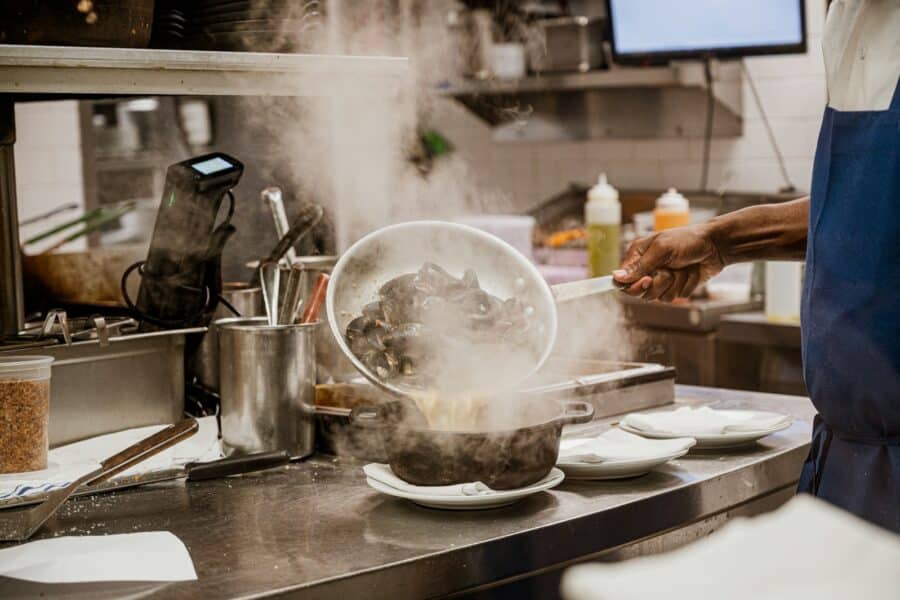 Restaurant kitchen staff cooking dinner service